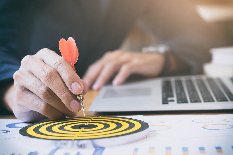 Business strategy success target goals. Businessman holding red dart push on target. Business strategy planning success target goals. Business development concept